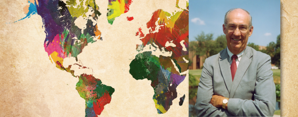 Picture of colorful world map on the left, and Jesse Fletcher with arms crossed and smiling on the right