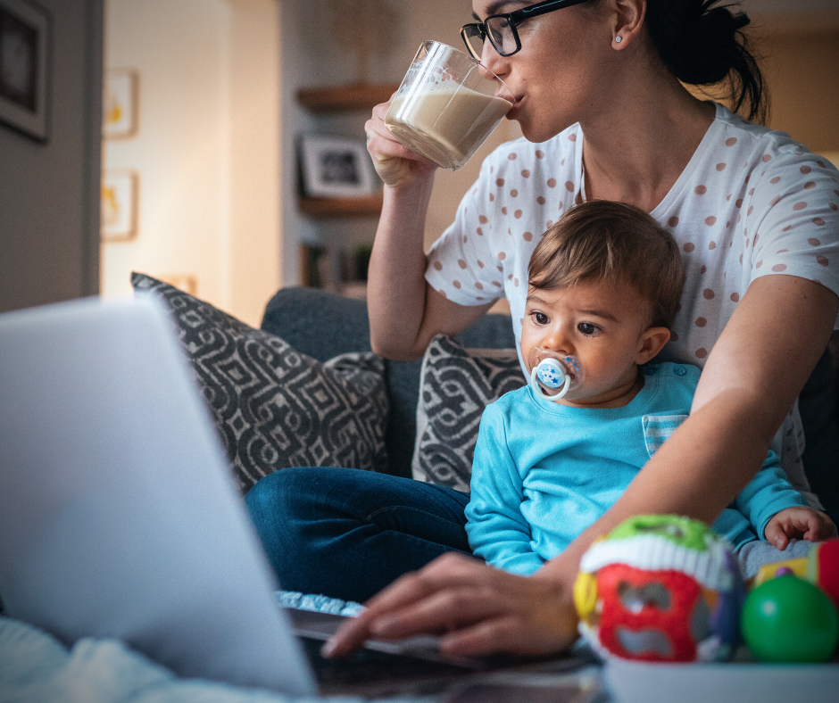 Picture of mother studying while holding a child