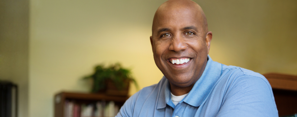 Closeup stock photo of middle aged black man smiling